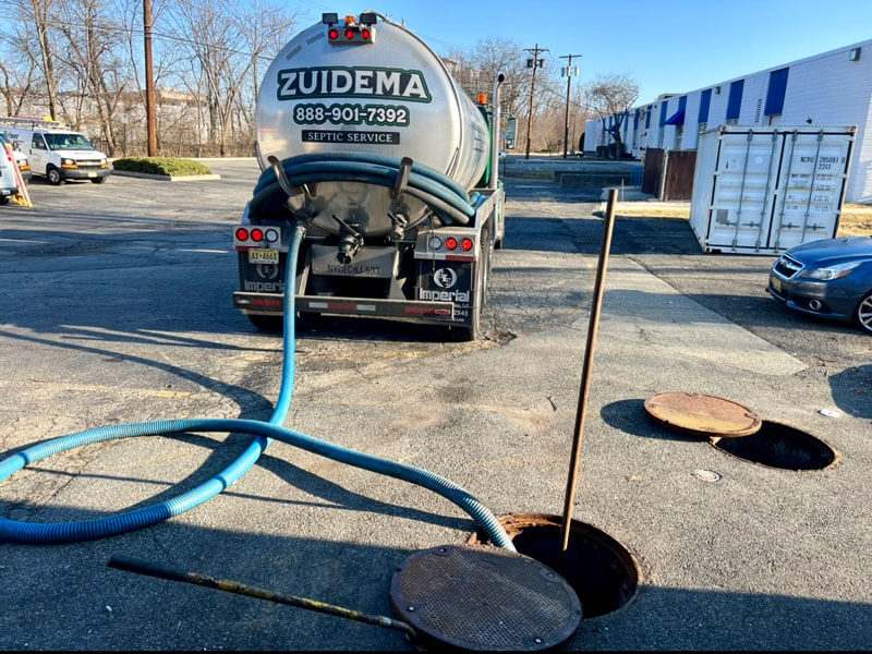 Experienced technicians performing septic system servicing with specialized equipment in NY& NJ